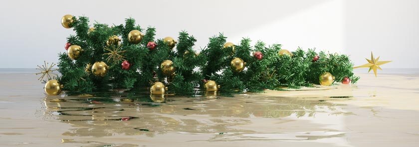 christmas tree laying down in flooded water in room